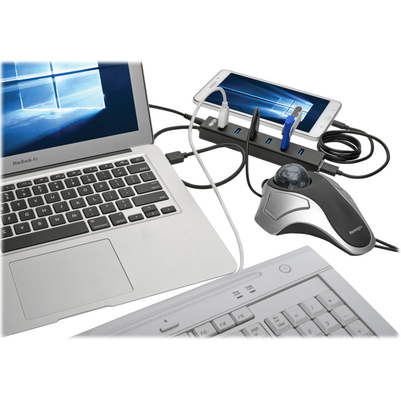 USB hub connected to MacBook Air with multiple peripherals including mouse, keyboard, and mobile device