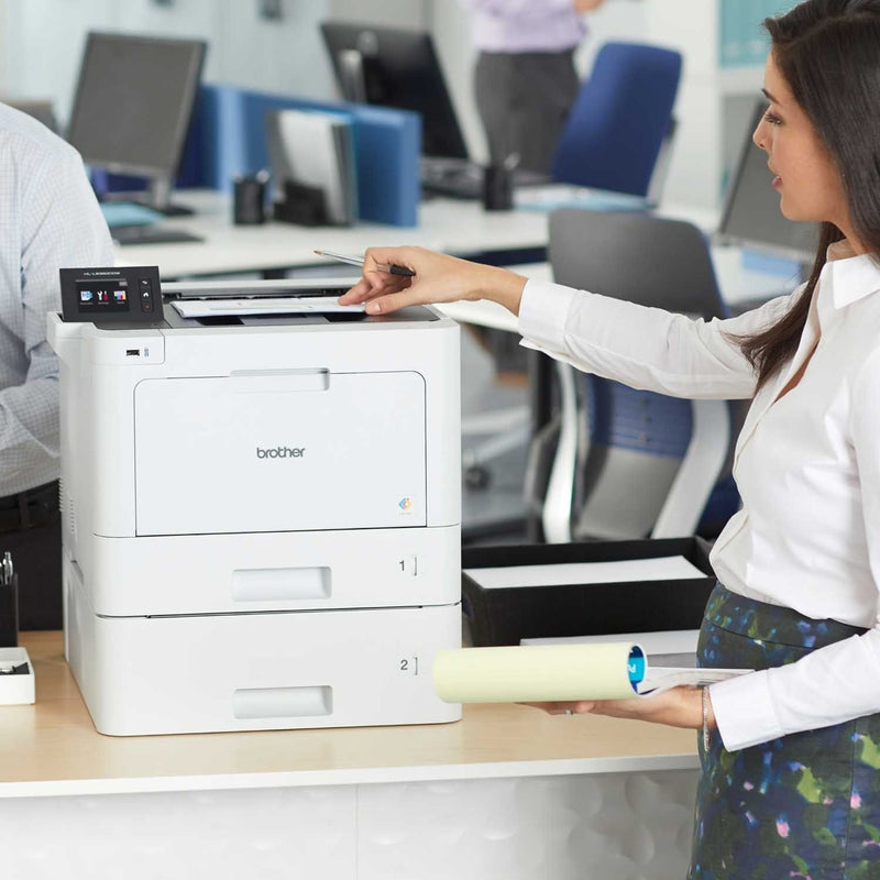 Office worker using Brother HL-L8360CDWT printer in workplace setting