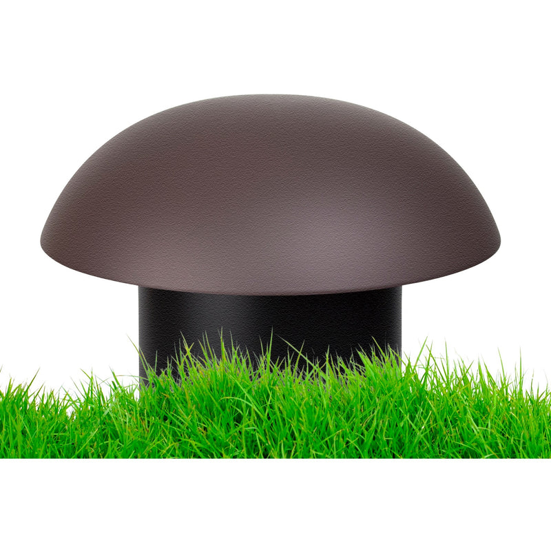 Close-up of Russound subwoofer vent cap emerging from grass, showing landscape integration