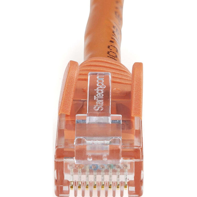 Macro shot of RJ45 connector pins and StarTech.com branding on orange Cat6 ethernet cable