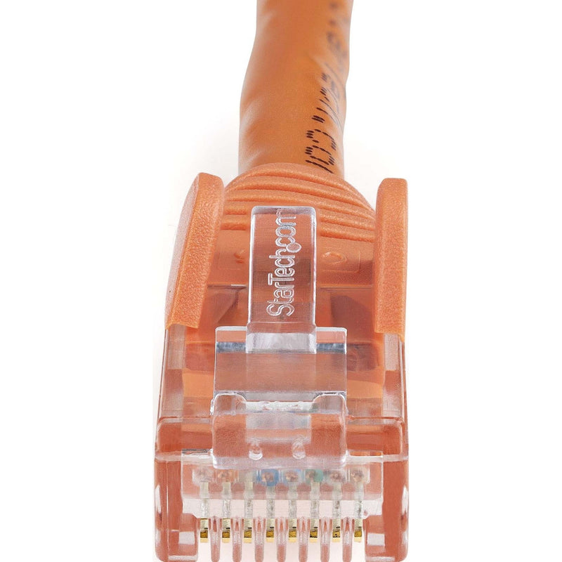 Macro shot of orange Cat6 ethernet connector showing internal pin arrangement and StarTech.com branding