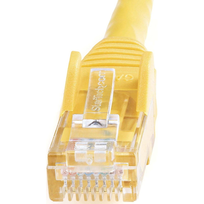 Detailed macro shot of yellow Cat6 ethernet connector showing strain relief and internal contact arrangement