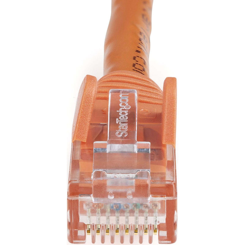 Macro shot of orange Cat6 ethernet connector showing internal gold pin layout and StarTech branding