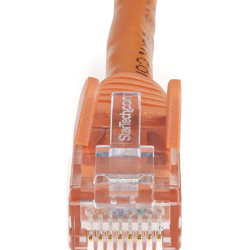 Macro shot of orange Cat6 ethernet connector showing internal pin configuration and StarTech.com branding