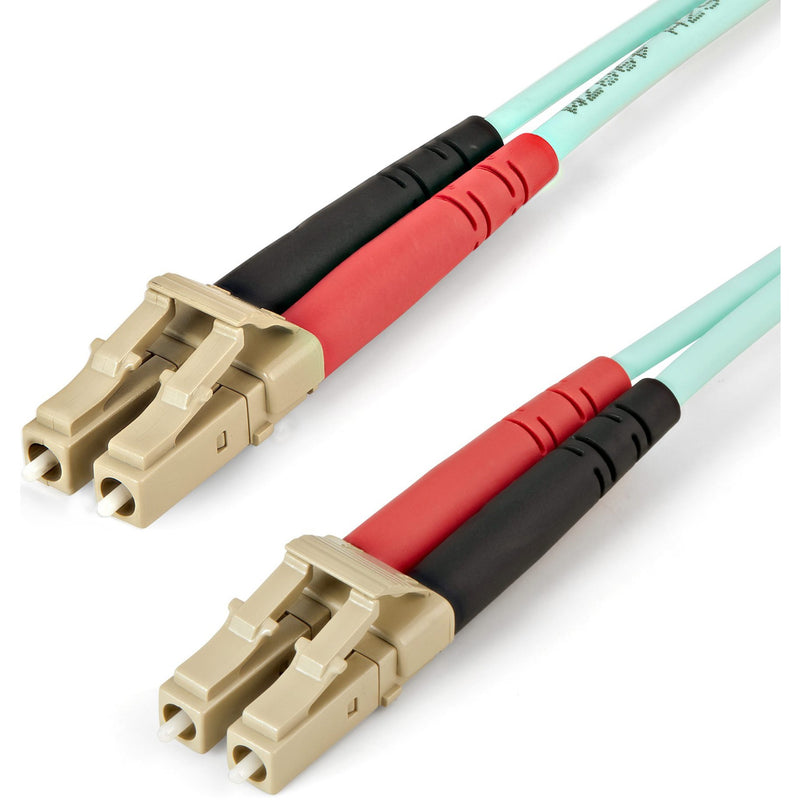 Close-up view of StarTech.com OM4 fiber optic cable showing LC connectors with red and black boots and aqua cable jacket