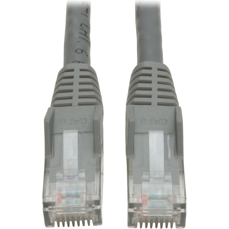 Close-up view of two gray RJ45 connectors with snagless boots and gold-plated contacts on Tripp Lite Cat6 patch cable