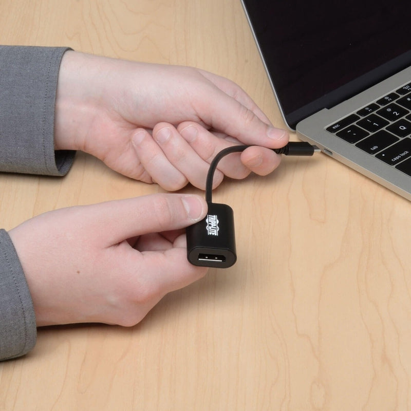 Close-up of USB-C connector being inserted into laptop port