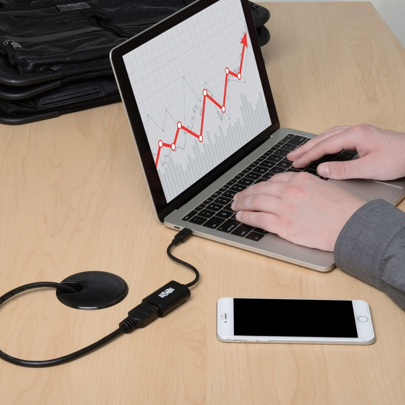 Close-up view of laptop with adapter connected showing data visualization