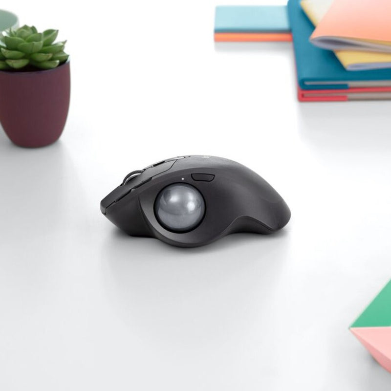 Logitech MX ERGO PLUS trackball mouse in modern office setting with minimalist desk accessories