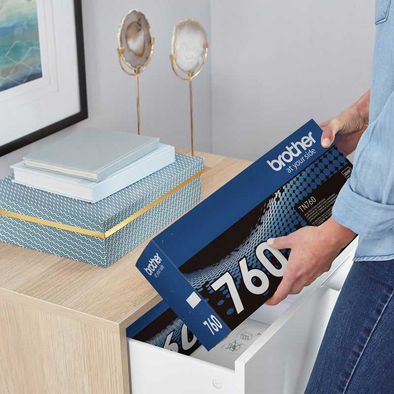 Person installing Brother TN-760 toner cartridge in office environment