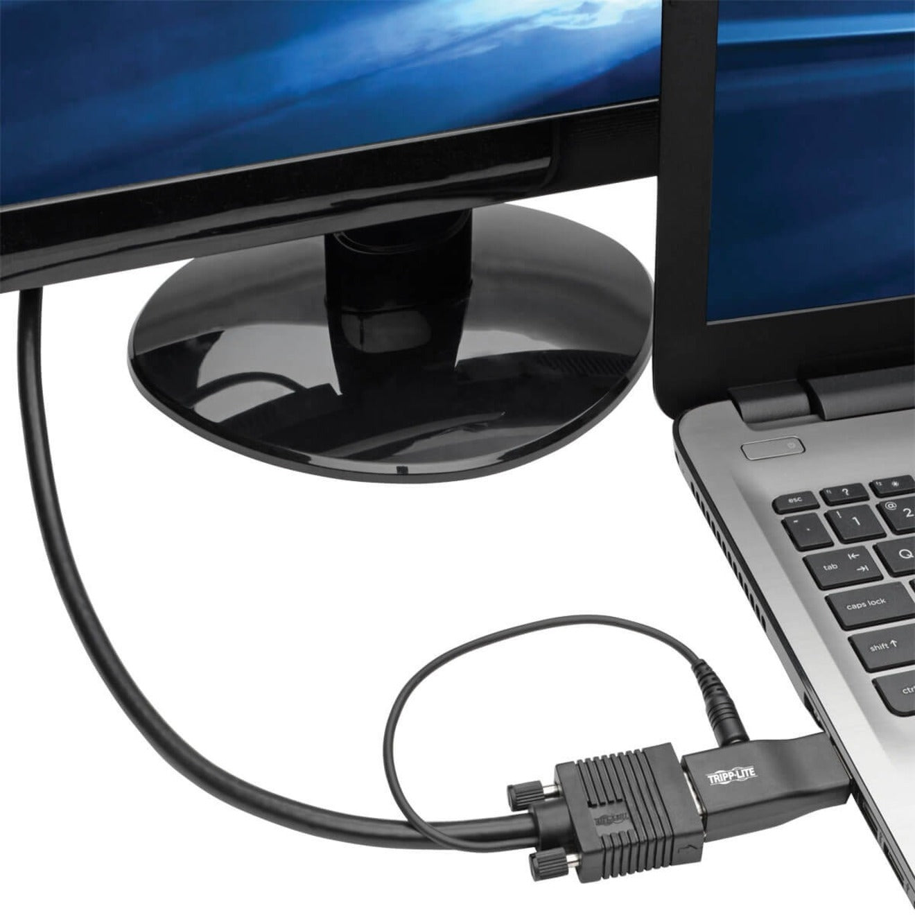 Tripp Lite adapter connected between a laptop and monitor, showing real-world usage scenario-alternate-image3