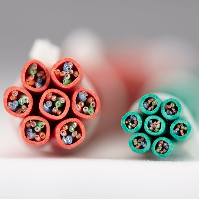 Macro photo showing internal twisted pair construction of Cat6 cable with red and green jacket colors