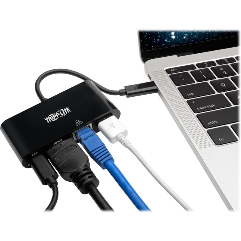 Tripp Lite adapter connected to laptop with multiple cables attached