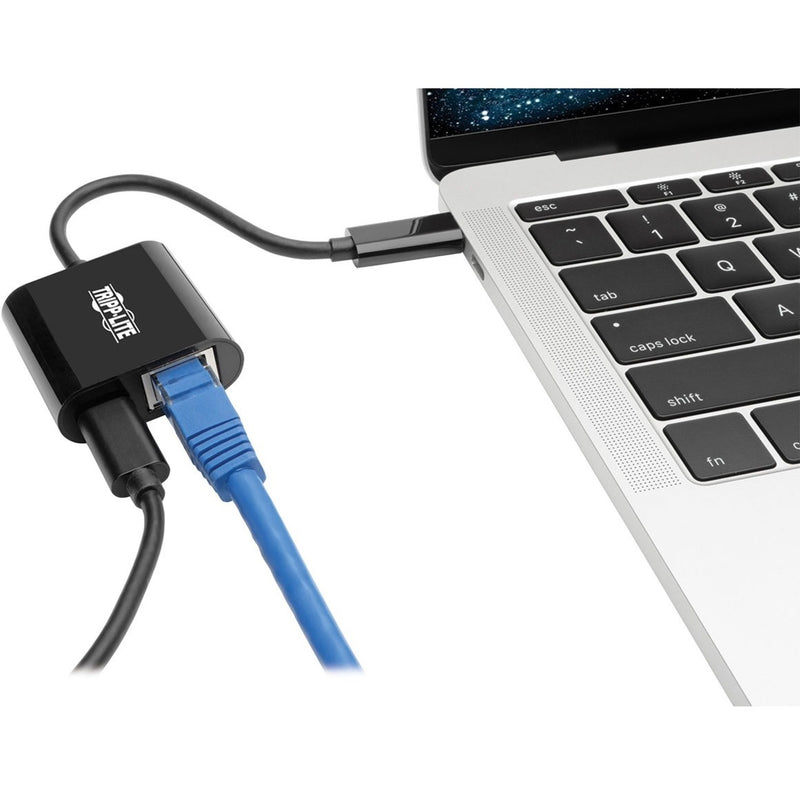 Tripp Lite adapter connected to MacBook with Ethernet cable attached