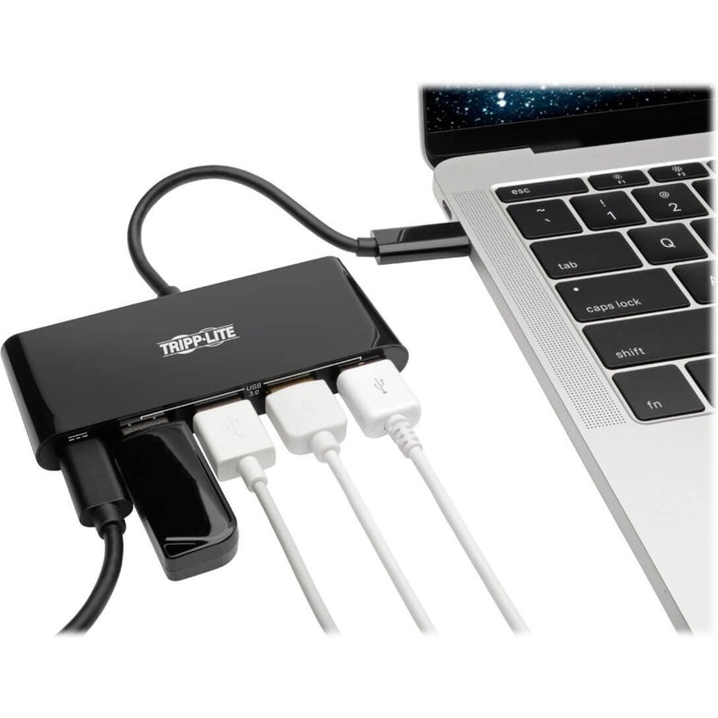 Tripp Lite USB hub connected to MacBook showing multiple USB devices plugged in