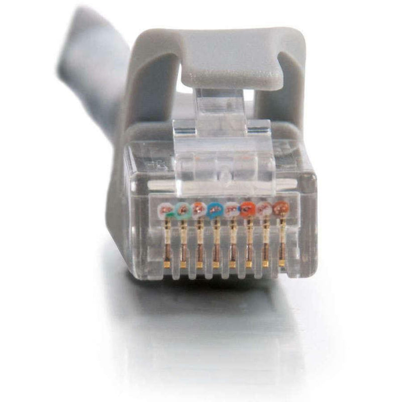 Macro shot of RJ-45 connector showing internal color-coded pins and crossover wiring configuration