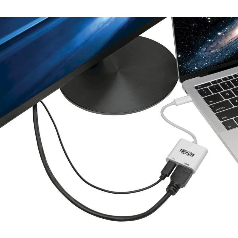 Tripp Lite adapter connecting a MacBook to an external monitor with space background