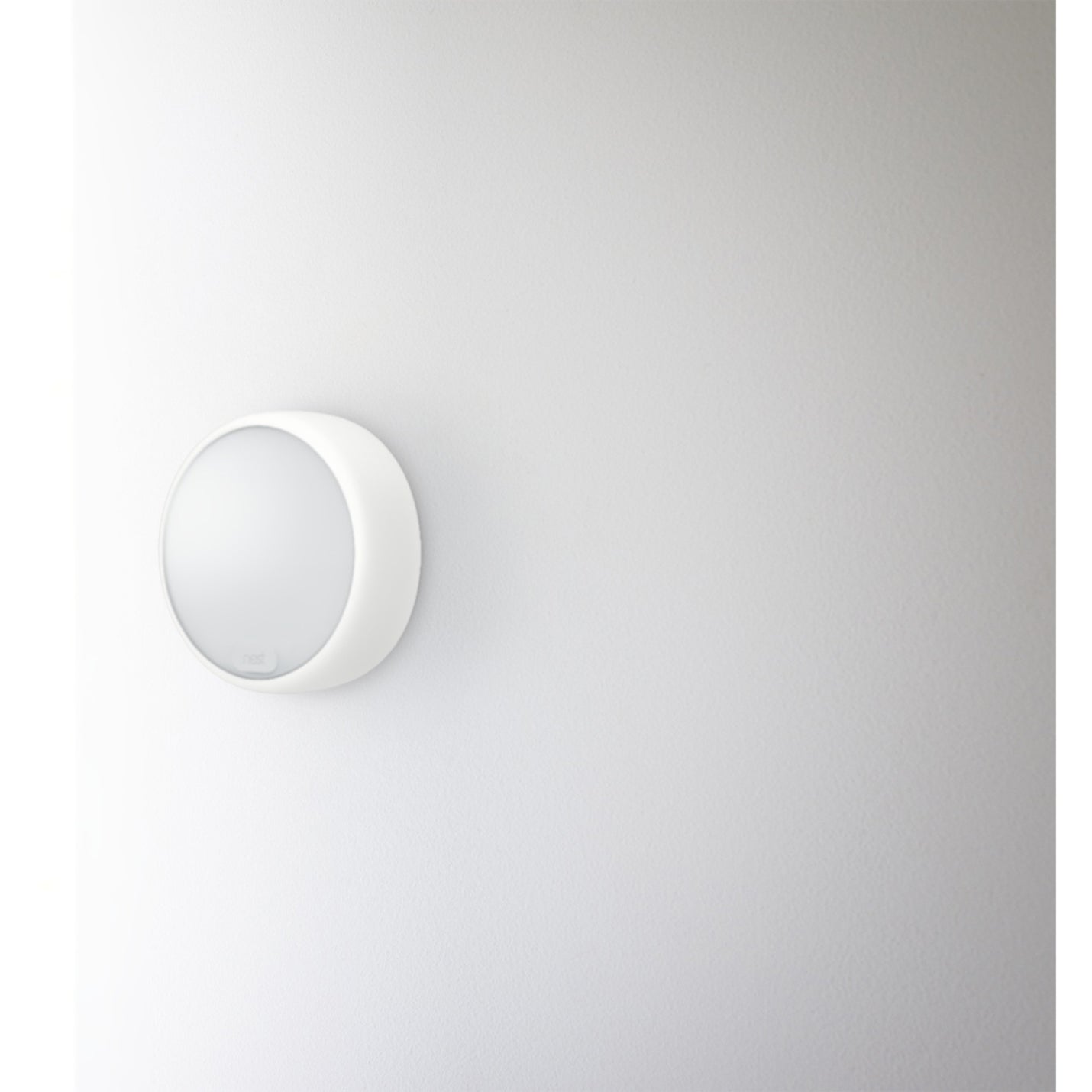 Close-up view of Nest Thermostat E showing minimalist white design-alternate-image5