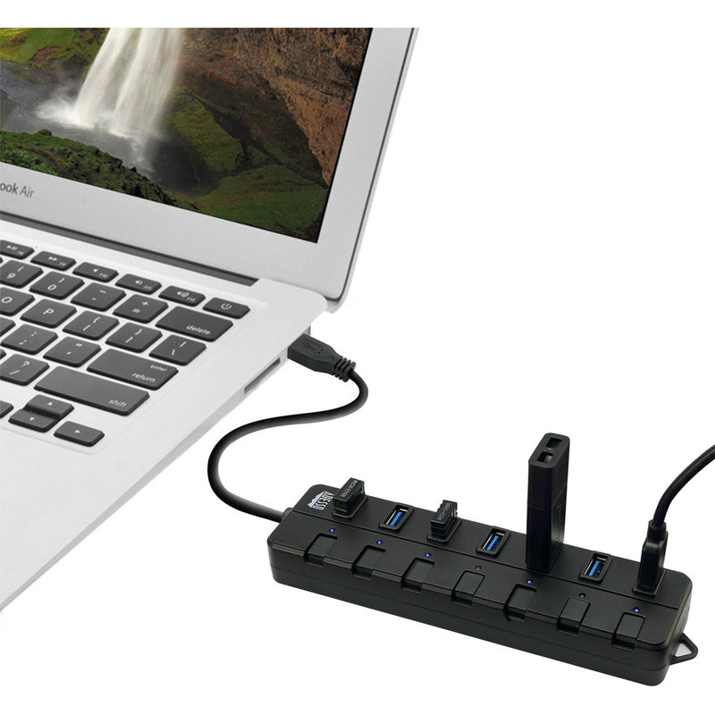 USB hub connected to a laptop showing practical usage scenario