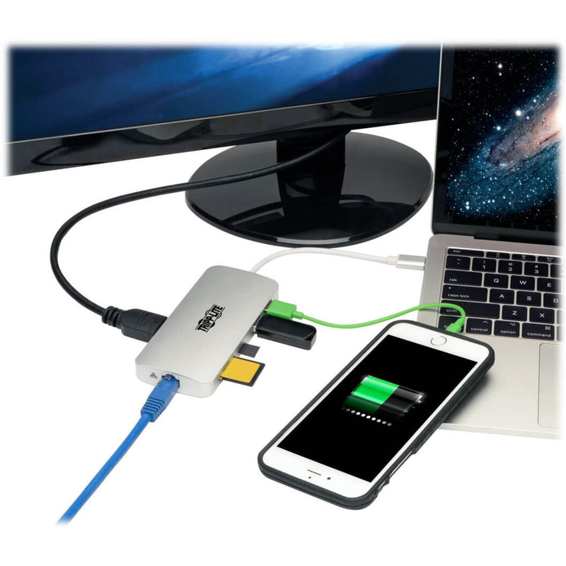 Docking station connected to laptop, display, and mobile device showing complete workstation setup