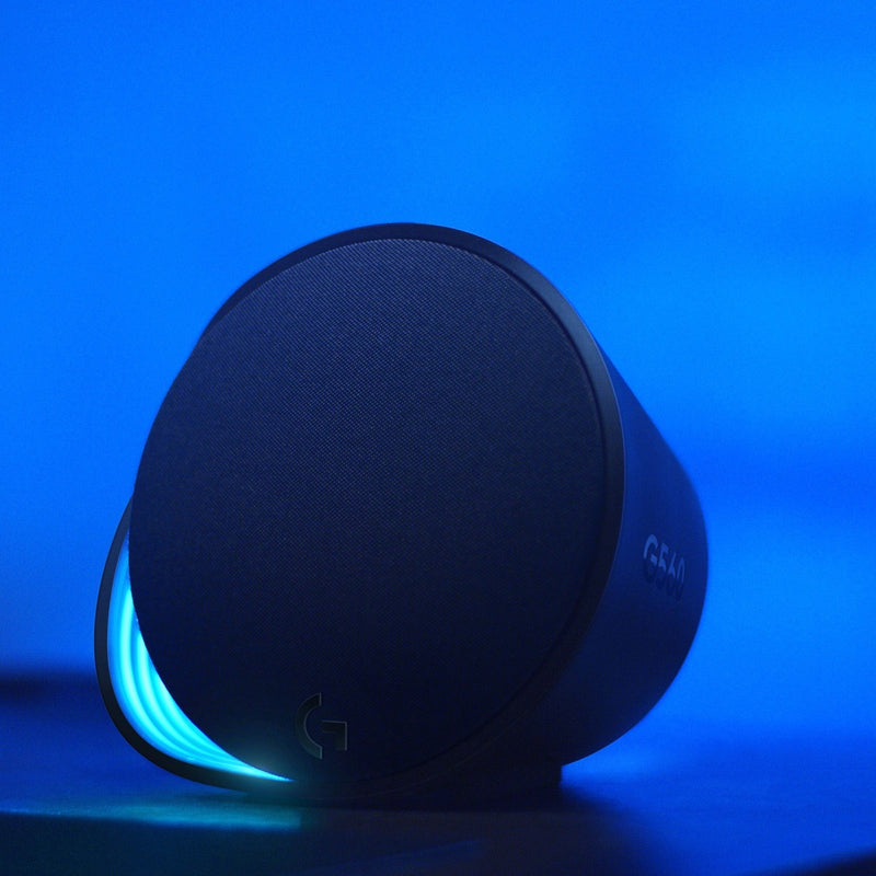 Close-up of Logitech G560 satellite speaker with blue LIGHTSYNC RGB lighting effect