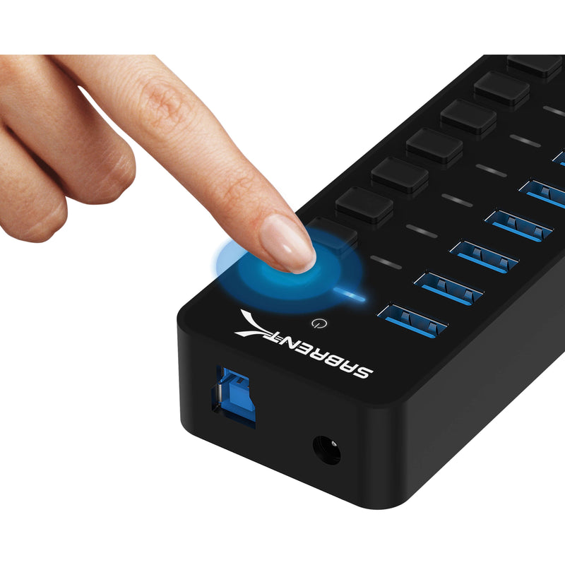 Close-up of finger pressing illuminated power button on Sabrent USB hub