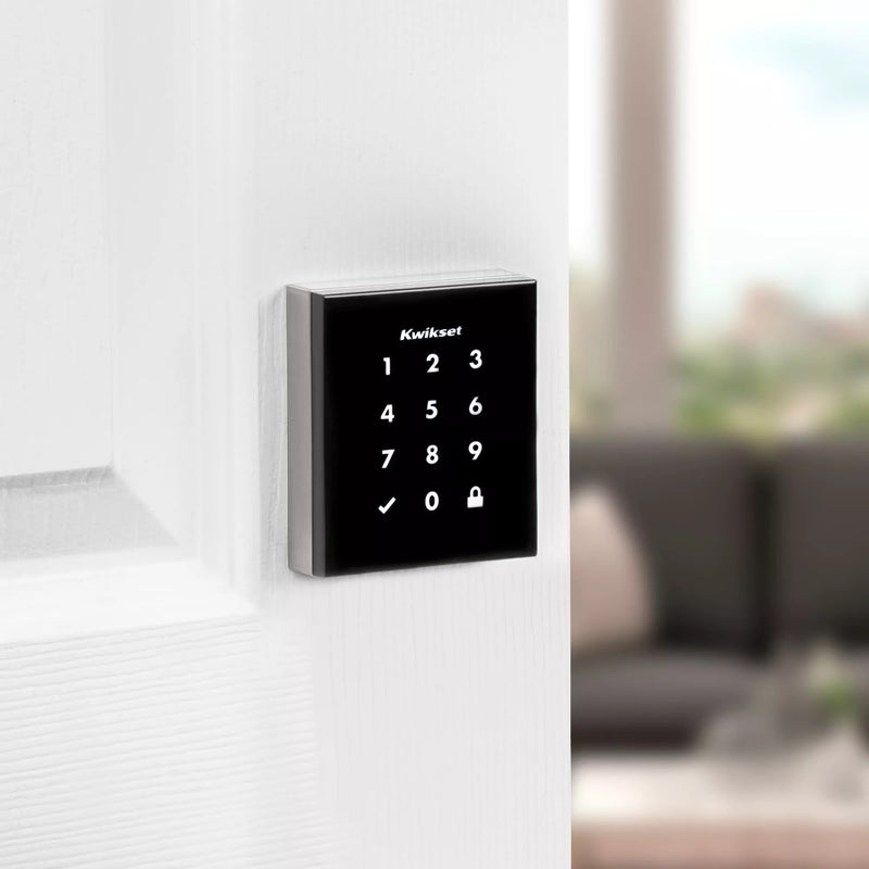 Profile view of Kwikset Obsidian smart lock installed on white door with modern handle