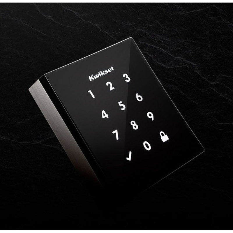 Angled view of Kwikset Obsidian smart lock showing illuminated keypad against textured background