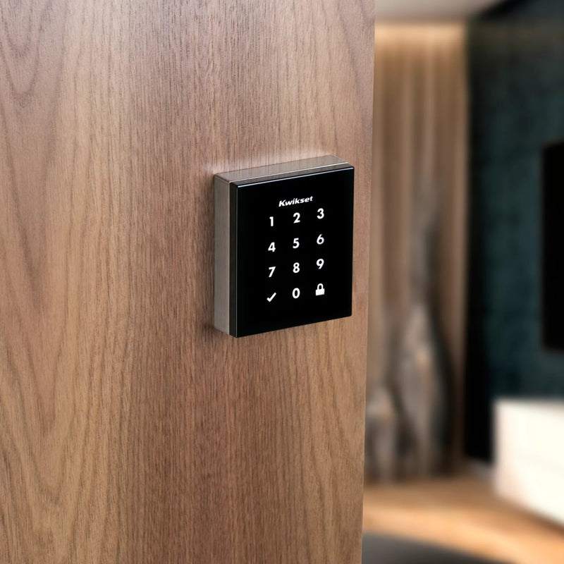 Kwikset Obsidian smart lock mounted on wooden door showing contrast and integration