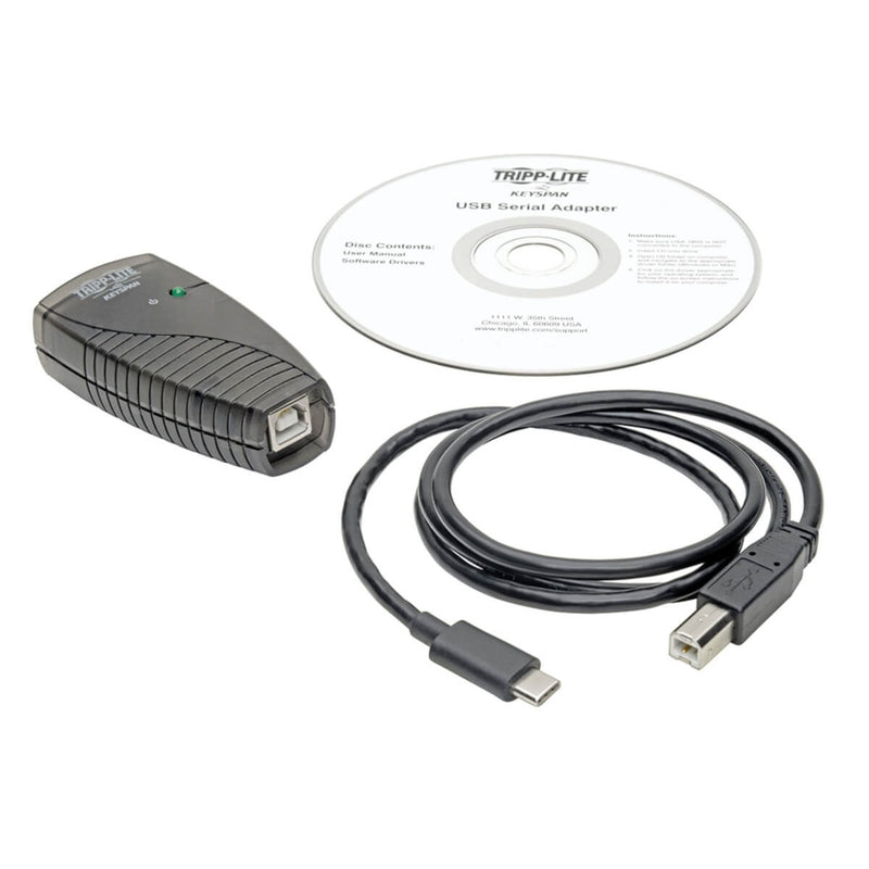 Complete package contents of Tripp Lite USB-C to serial adapter including cable and software CD