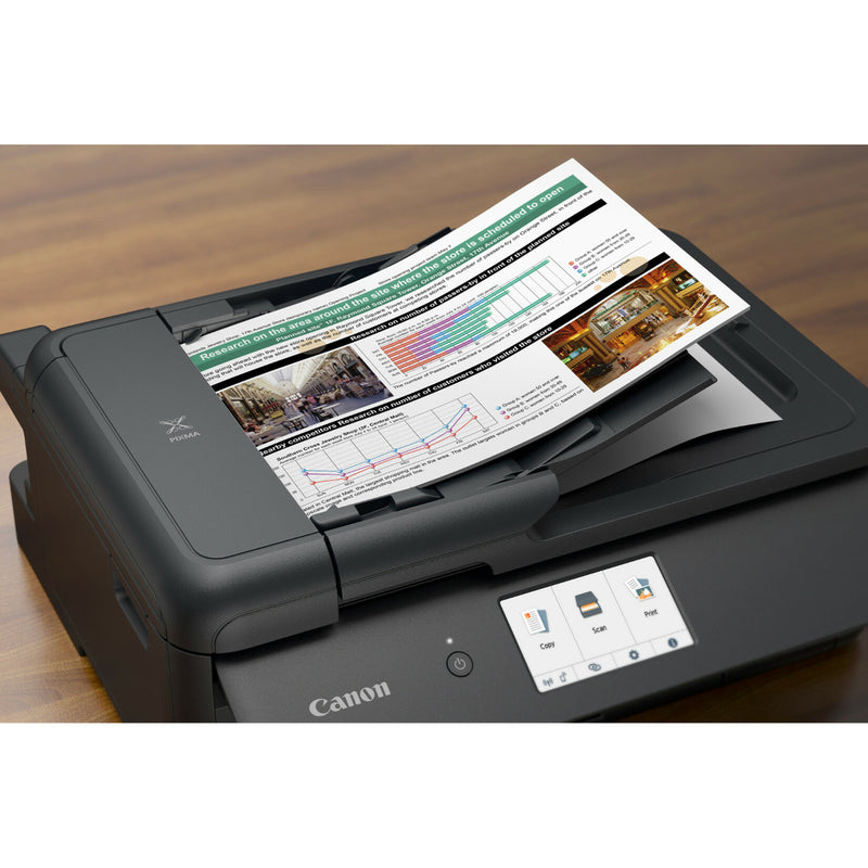 Canon PIXMA TS9520 scanning a business document with graphs and charts