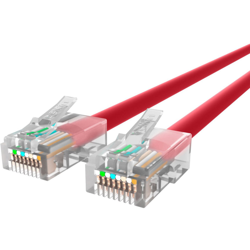 Close-up view of transparent RJ45 connectors showing internal wiring and pin configuration on red Cat5e cable