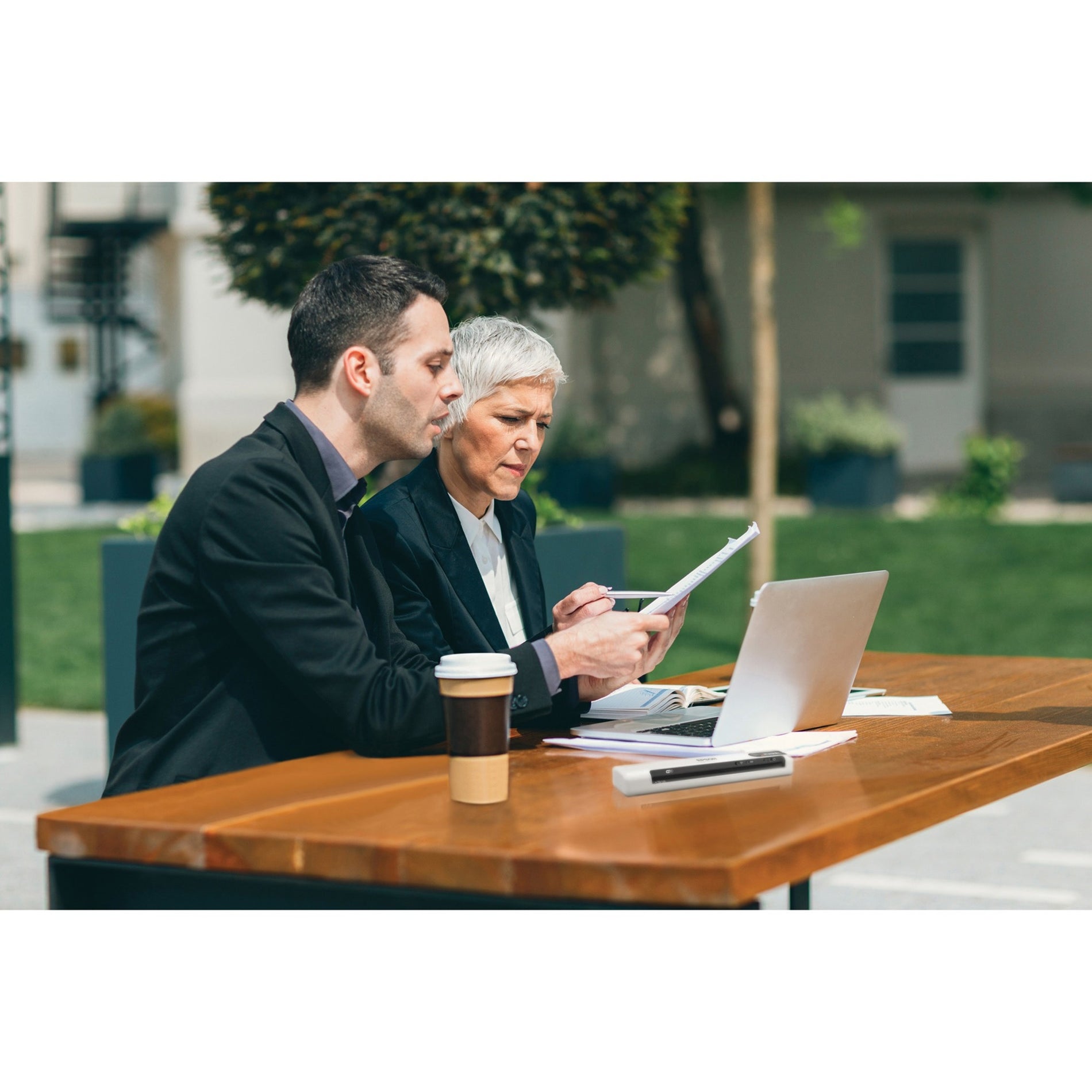 Business professionals collaborating with scanner and laptop outdoors-alternate-image14