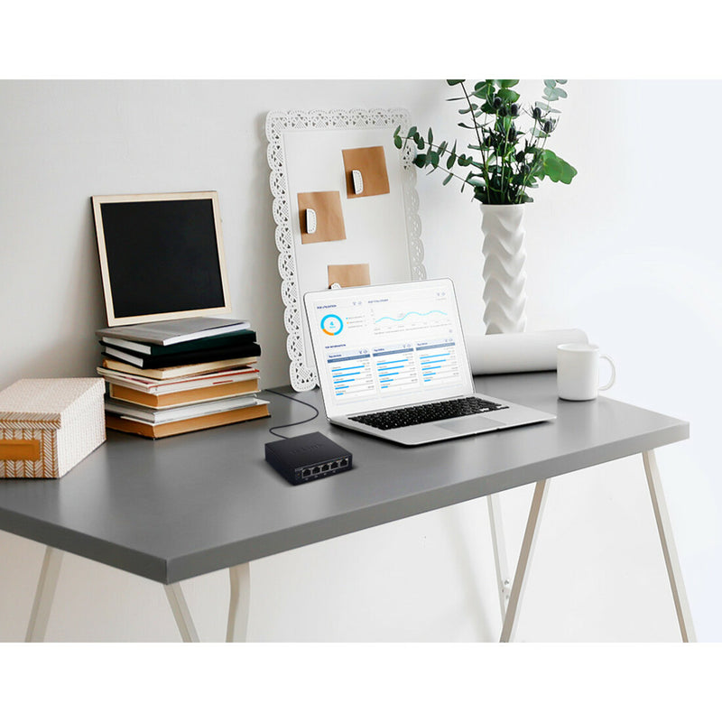 D-Link switch in a modern office setup with laptop and desk accessories