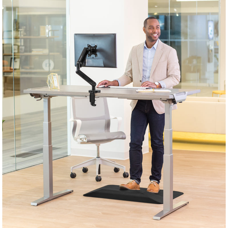 Professional working at Fellowes Levado desk in standing position with anti-fatigue mat