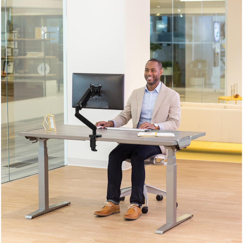 Professional using Fellowes Levado desk in seated position with ergonomic setup