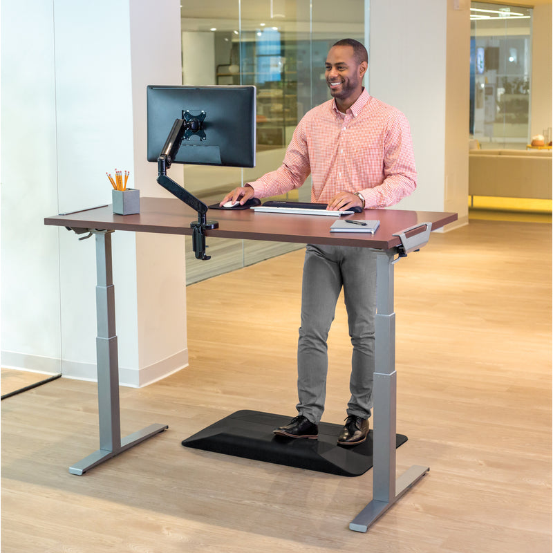 Professional using Levado standing desk in active working position