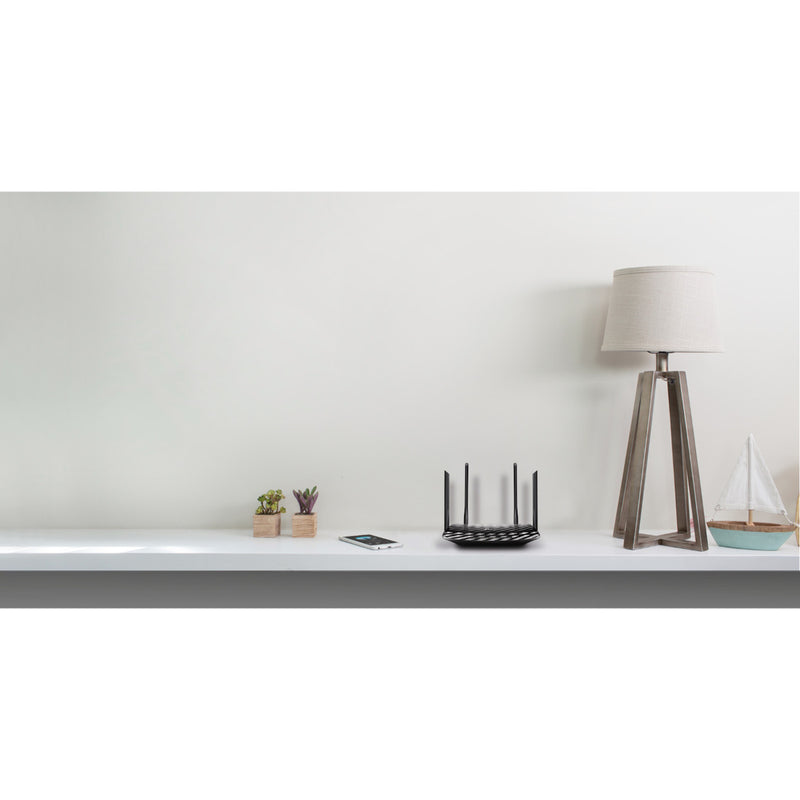 TP-Link Archer A6 router in a minimalist home setting with decorative items