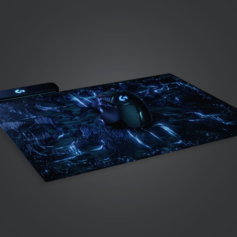 Logitech G502 LIGHTSPEED mouse on RGB mousepad showing synchronized lighting effects