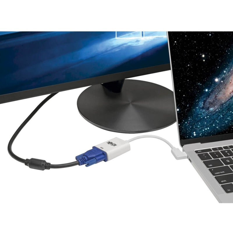 Tripp Lite USB-C to VGA adapter connected between a laptop and monitor showing practical usage