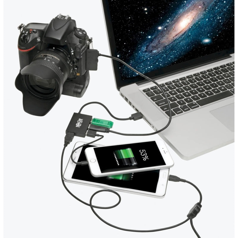 USB hub connected to laptop with DSLR camera and mobile devices showing practical usage scenario