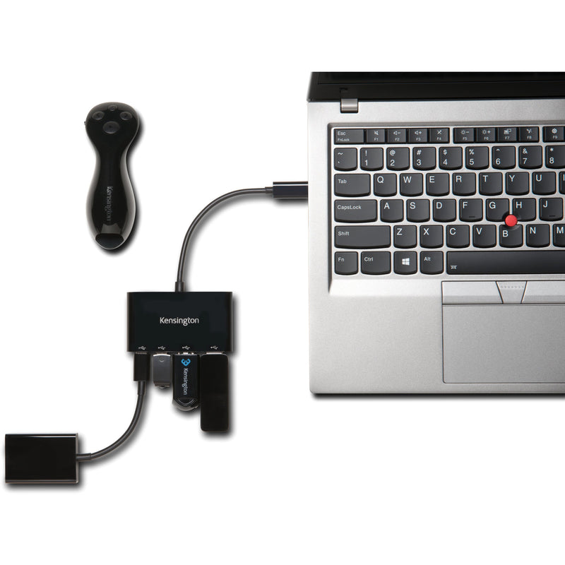 Kensington CH1000 USB-C hub connected to a laptop with multiple USB devices demonstrating practical usage