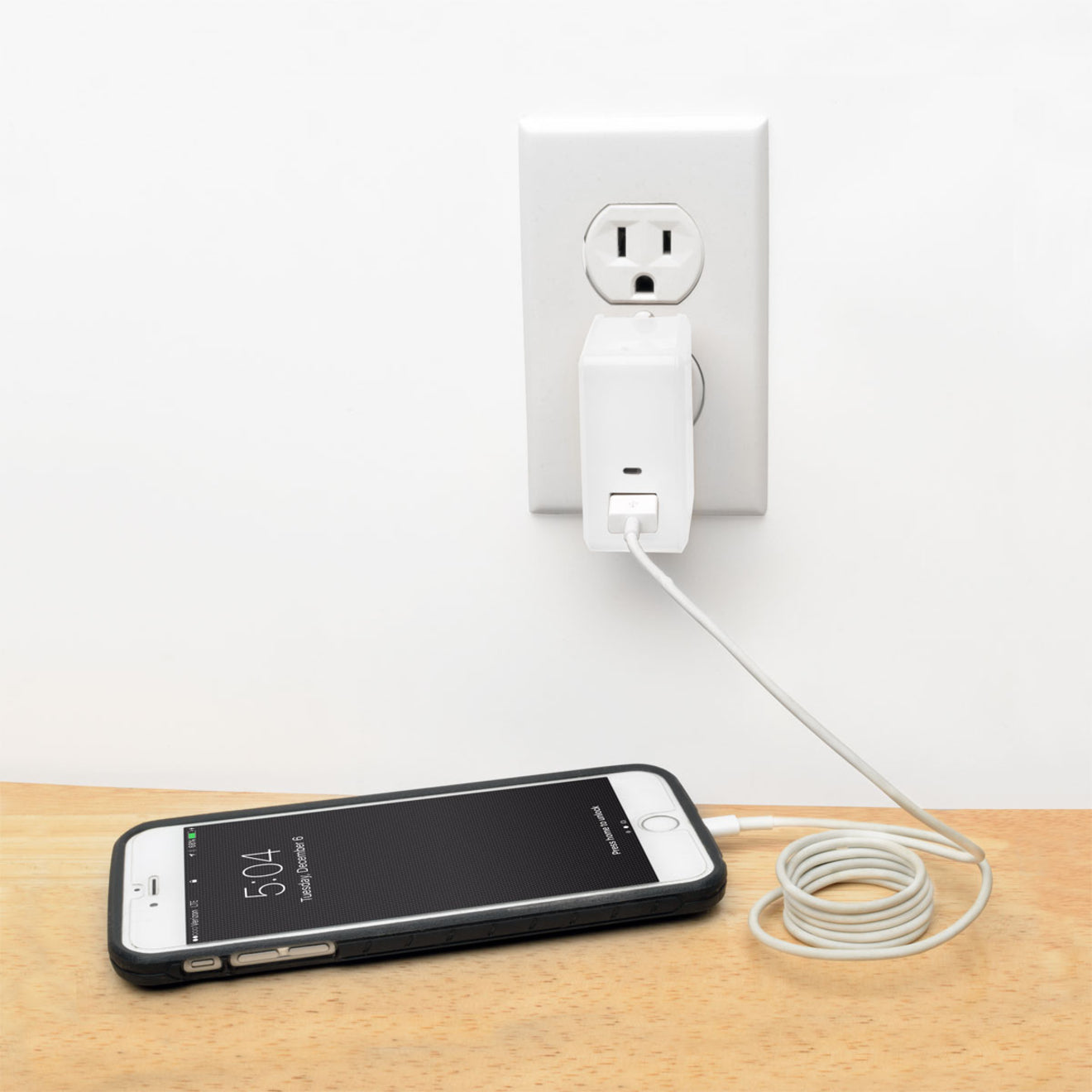 Tripp Lite charger in use charging a smartphone on wooden surface-alternate-image6