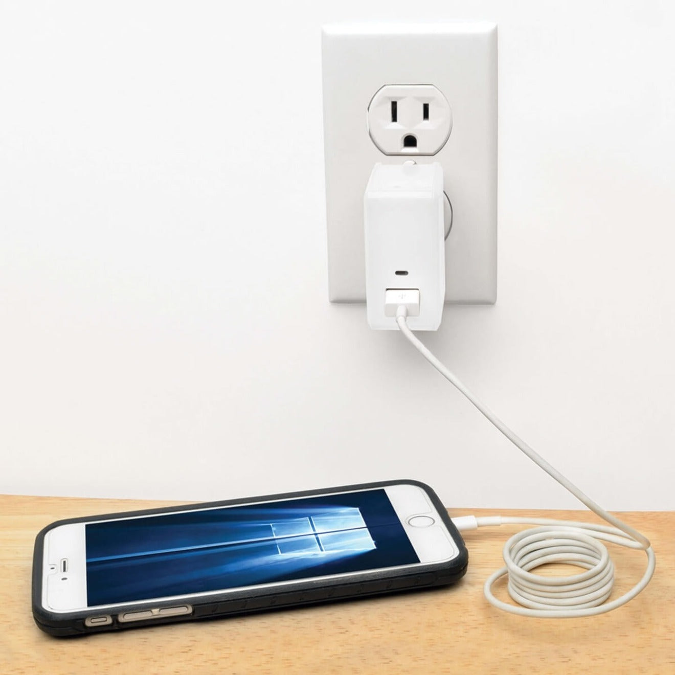 Tripp Lite charger plugged into wall outlet charging a smartphone-alternate-image3