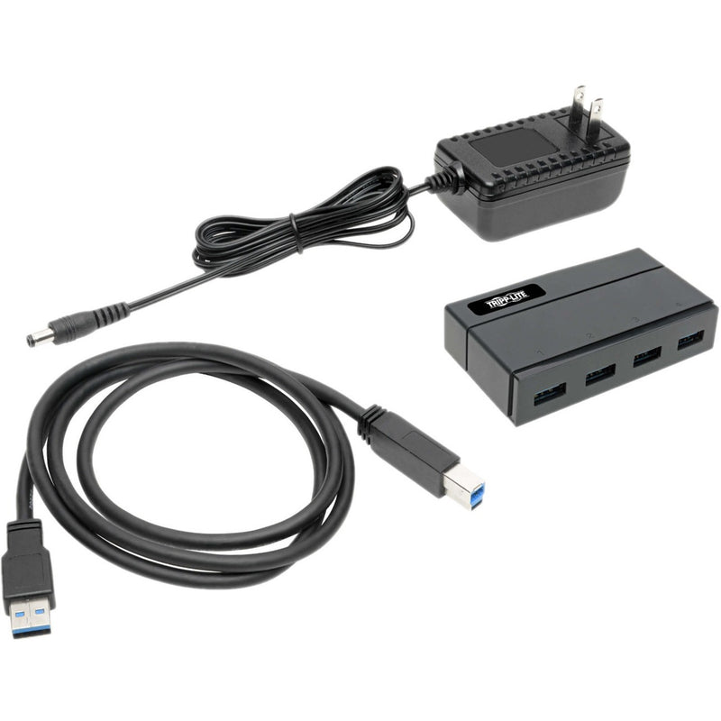 Complete USB hub package showing hub, USB cable, and power adapter