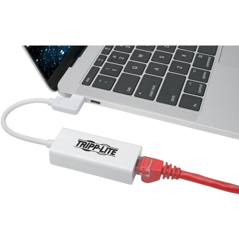 Tripp Lite adapter connected to laptop with red ethernet cable