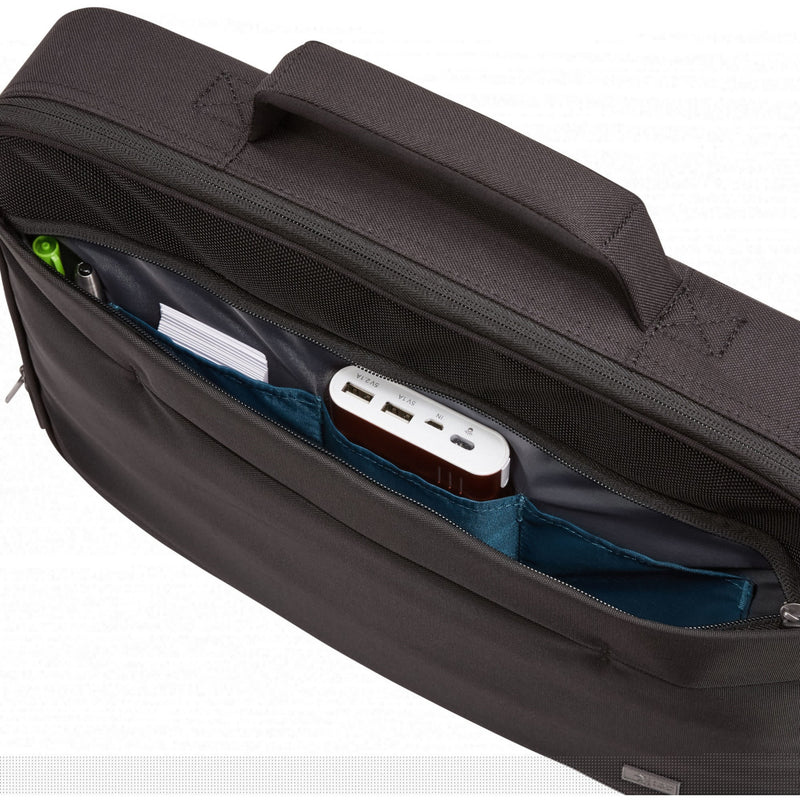 Close-up of briefcase accessory pocket containing charging hub and cables