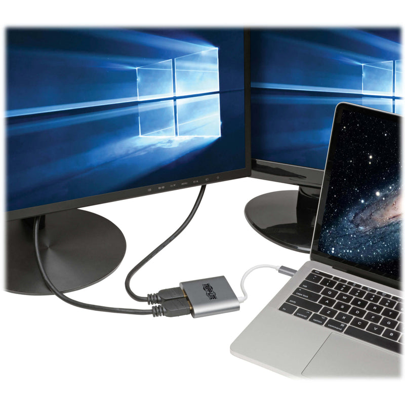 Tripp Lite adapter connected between laptop and dual monitors showing Windows desktop