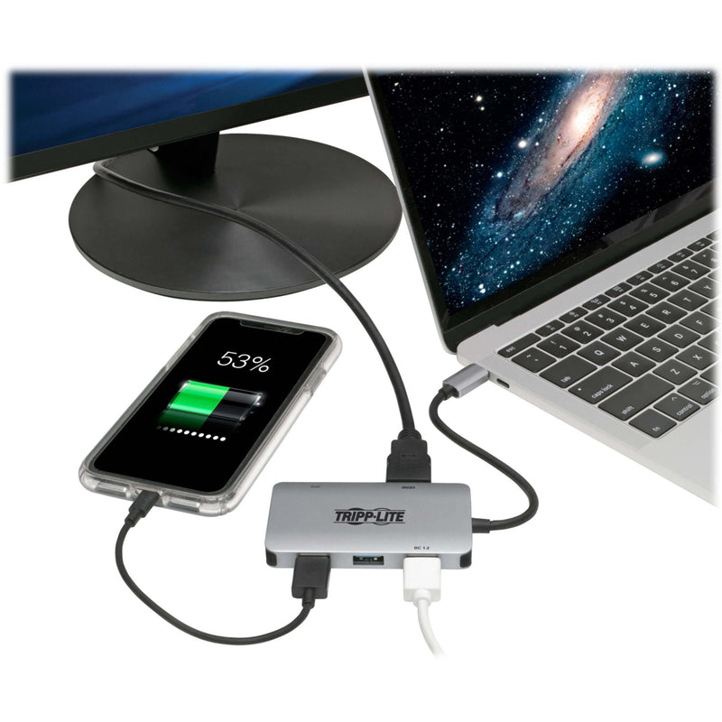 Tripp Lite adapter connected to laptop and phone showing charging capability