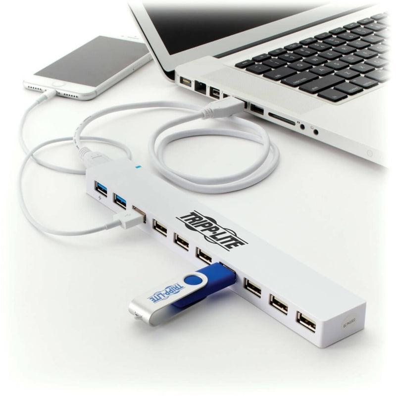 Tripp Lite USB hub connected to a laptop and smartphone with USB flash drive, showing real-world usage scenario